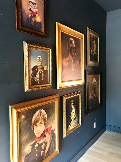 Hilarious Star Wars characters sit for oil paintings displayed on a gallery wall in a fun bedroom by Dana Lynch at the Pinewood Forest Idea House. Photo: Sherry Hart. #starwars #oilpaintings #whimsicaldecor #humor #artgallerywall #tealwalls #pineforestideahouse #atlantashowhouse