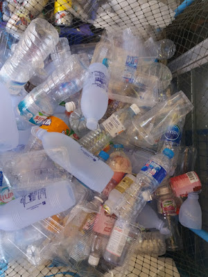 photo of an amount of plastic bottles at a recycling station