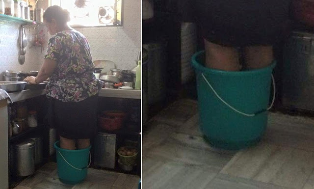 Despite Of Deep Pain In Legs A Mother Stands In Hot Water