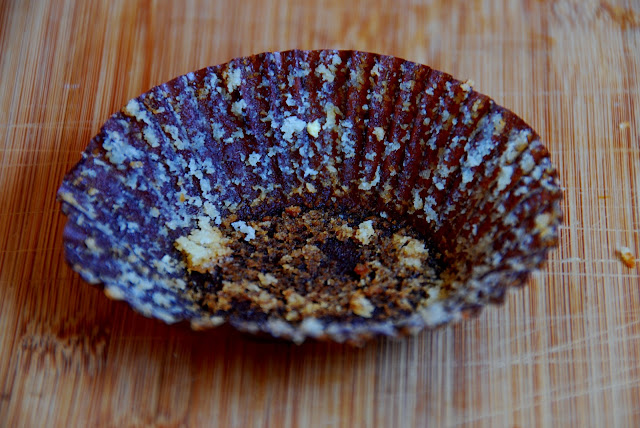 empty brown cupcake wrapper with crumbs after eating cupcake