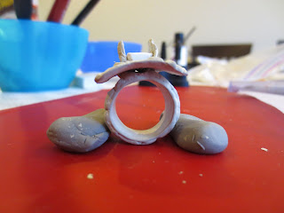 Metal clay ring drying between two pieces of polymer clay