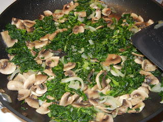 mushrooms, onions, and spinach in a pan 
