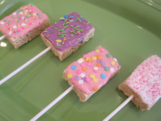 Easter Rice Krispie Pops are rice Krispie treats dipped in candy coating and covered in sprinkles and peeps. Life-in-the-Lofthouse.com