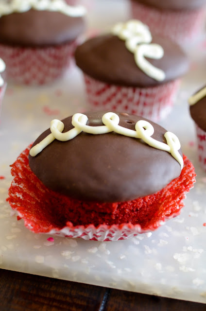 Copycat Hostess Cupcakes with a Valentine's day twist. These cream filled red velvet cupcakes are topped with ganache and are oh-so-good!