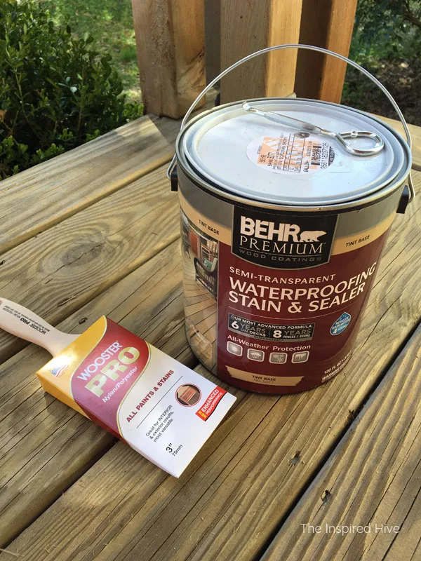How to refinish your old wood front porch. We used Behr Cordovan Brown and Pinto White stains. The HomeRight Paint Stick helped us update our farmhouse front porch the easy way!