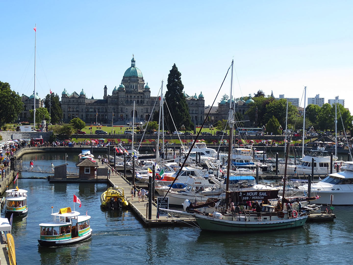 Boats are moored in the inner harbor, downtown Victoria, BC