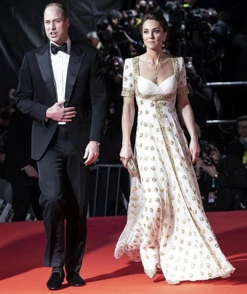 The Duchess wore a gown by Alexander McQueen. Jimmy Choo Romy gold pumps, She carries Anya Hindmarch gold glitter box clutch