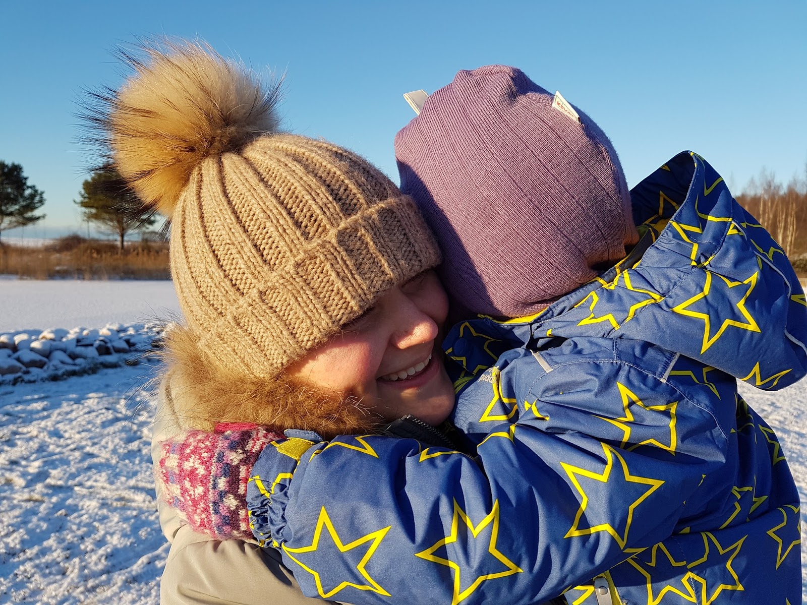 mum cuddling daughter in freezing outdoors