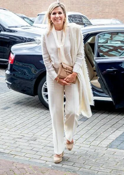 Queen Maxima wore Massimo Dutti ivory silk blouse with bow and trousers, Cartier Gold Bamboo earrings