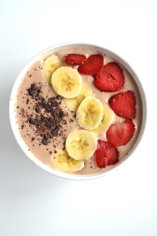 This Banana Split Smoothie Bowl tastes like your favorite dessert but is much healthier! It has banana, strawberries and chocolate to make it just like a banana split! www.nutritionistreviews.com
