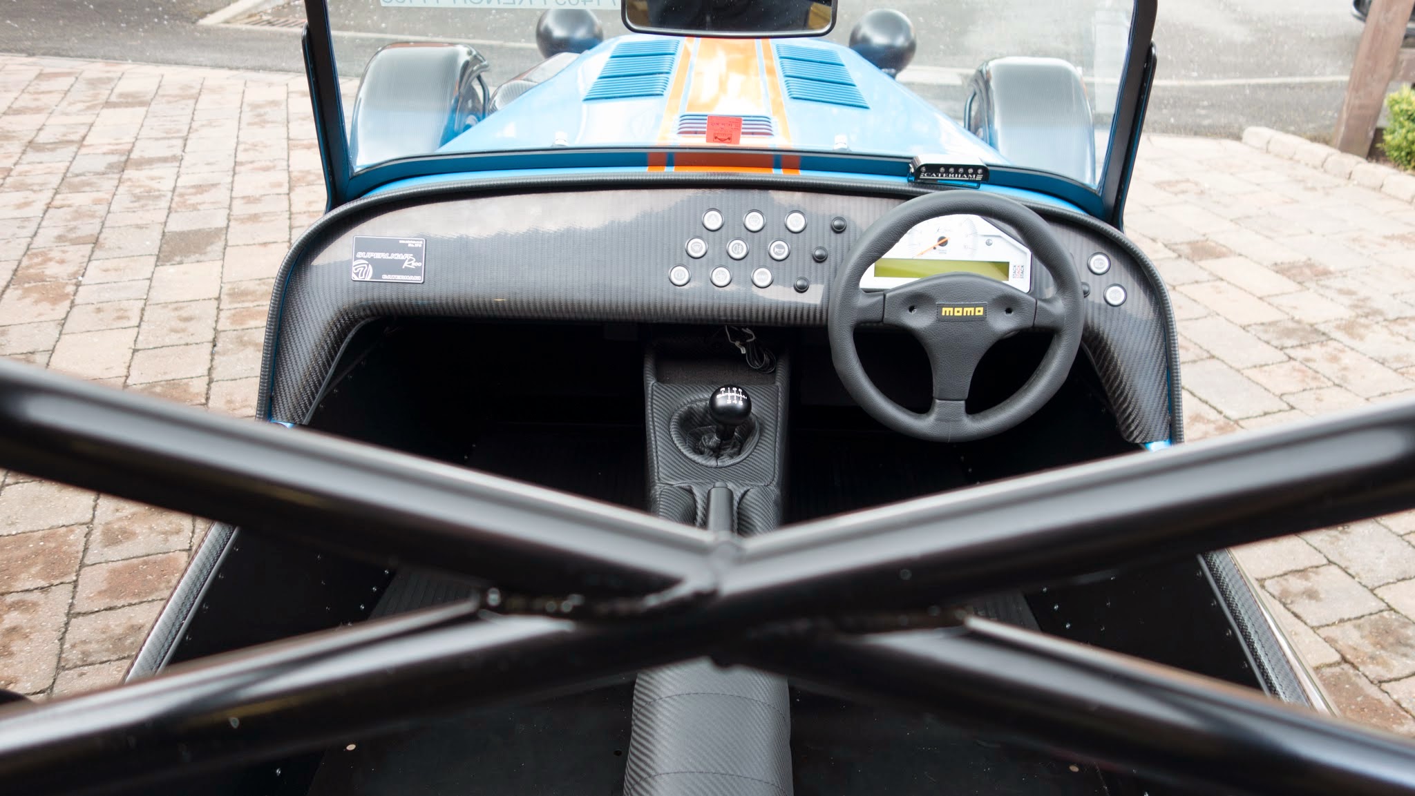 Overhead shot of interior with track day roll bar in foreground.