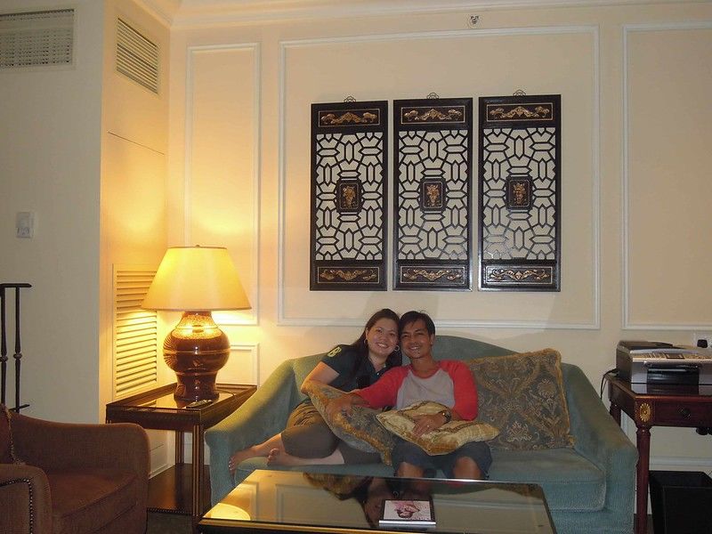 Couple travel blogger relaxing at the living room of their room at The Venetian Macao Resort Hotel