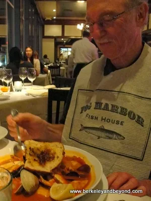 diner tucks into cioppino at Fog Harbor Fish House in San Francisco