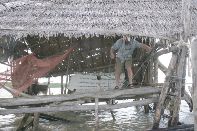 The shrimp shack is put together with scraps of rope and the monsoon rains have started. 