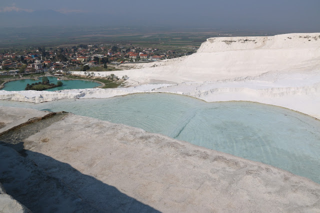 Removing shoes before stepping into travertines terraces at Pamukkale Thermal Pools (Cleopatras) pools in Turkey Removing shoes before stepping into travertines terraces at Pamukkale Thermal Pools (Cleopatras) pools in Turkey