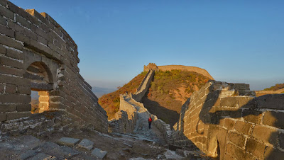 Visitors walk along the Badaling section of the Great Wall of China, some 70 kilometres north of Beijing on April 11, 2012. The Great Wall of China is a series of fortifications made of stone, brick, tamped earth, wood, and other materials generally built along an east-to-west line across the historical northern borders of China in part to protect the Chinese Empire against intrusions by various nomadic groups or military incursions.