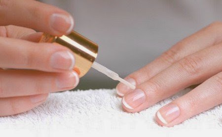 applying white nail polish