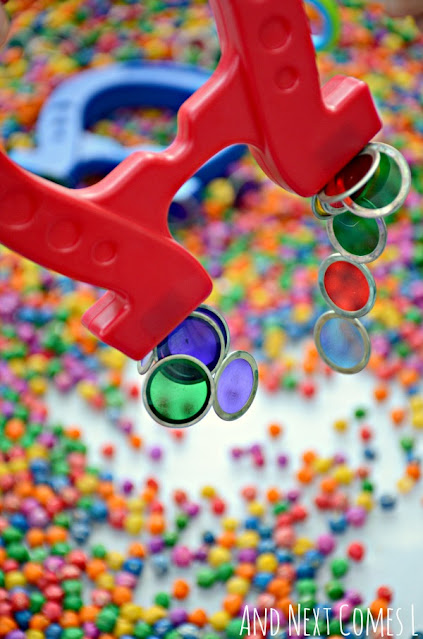 Close up of magnetic transparent counters stuck to a red horseshoe magnet