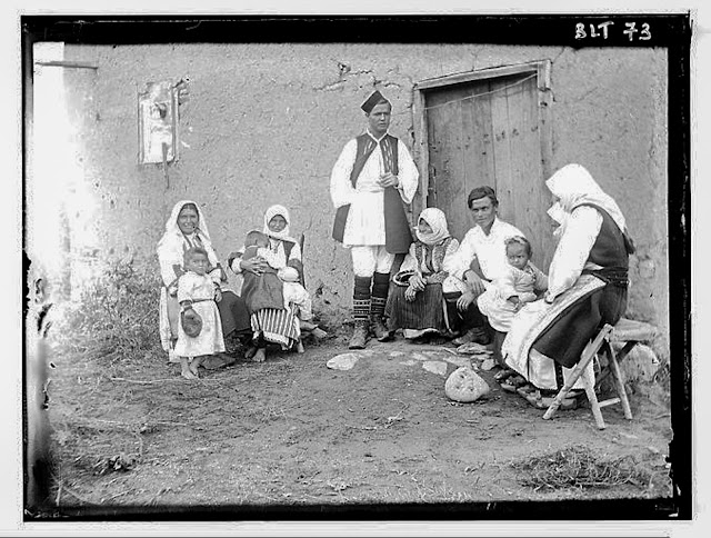 Macedonian family posing in front of a house, village Negochani (Niki)
