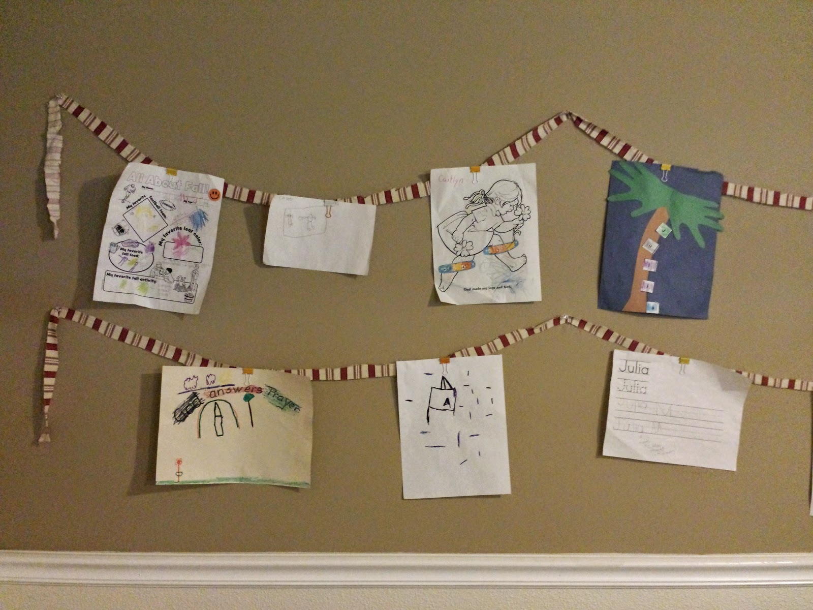 using strips from an old tablecloth to hang pictures