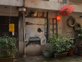 mural of woman looking out a window