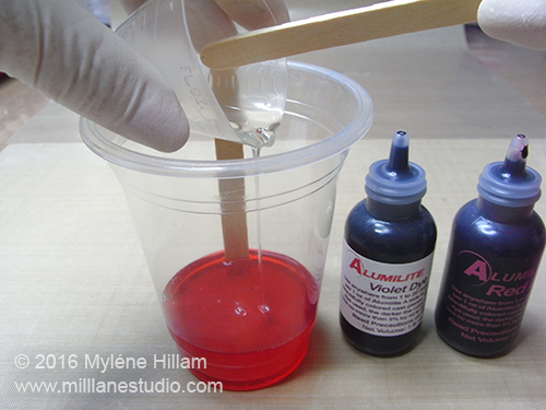 Mix Parts A and B together really well. Working quickly, add 1 or 2 drops of each of the red and violet dyes and swirl them lightly through the resin.