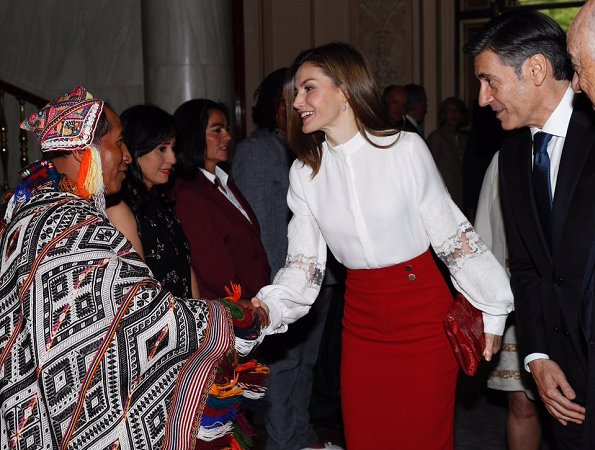 Queen Letizia wore Hugo Boss Vasela-Slim fit pencil skirt, and Hugo Boss Staple red pumps carried Carolina Herrera Animal Print Clutch