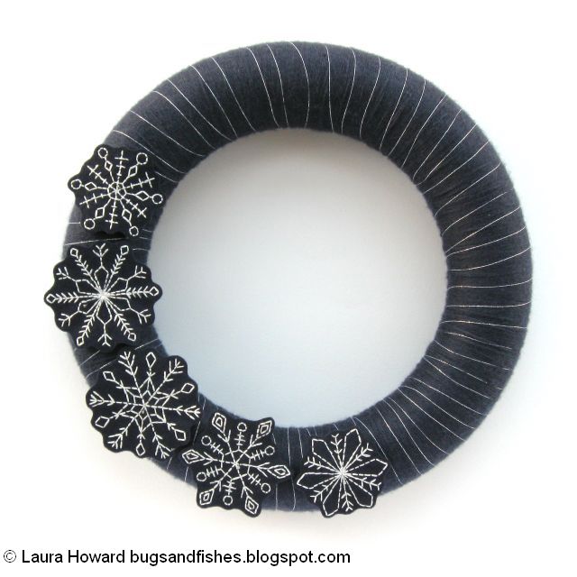 arrange the embroidered snowflakes on the wreath