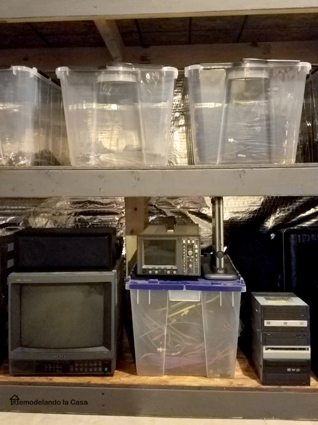 shelves filled up with cables and electronics in clear plastic totes