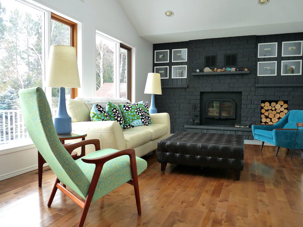 Living room with grey fireplace, marimekko pillows, lotte lamps