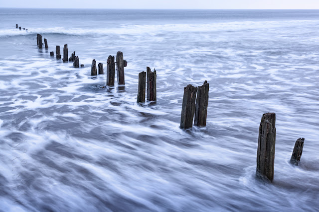 The ocean slips between the beach groynes at Sandsend by Martyn Ferry Photography