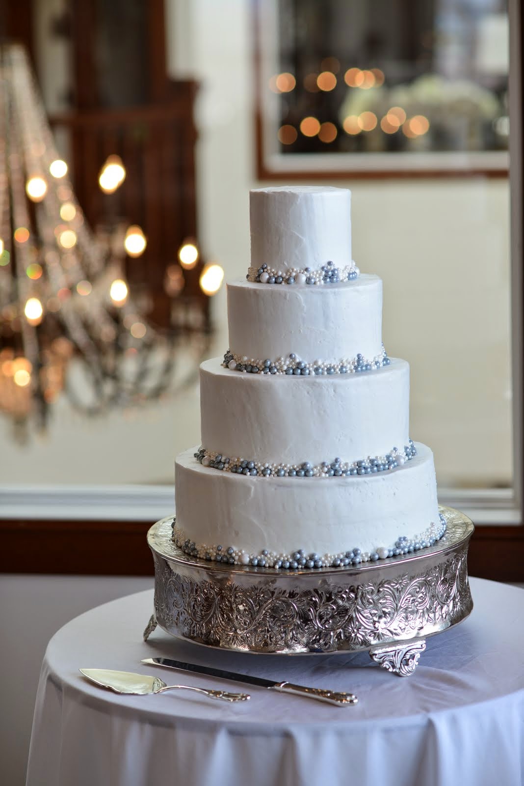 4-tier round buttercream with edible pearls
