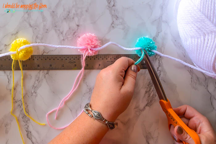 How to Make a Pom Pom Garland | Follow this easy tutorial to make a fun and fluffy yarn garland in minutes.
