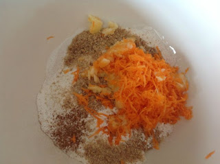 Grated carrot, grated apple, flour, oatibix and cinnamon in a bowl