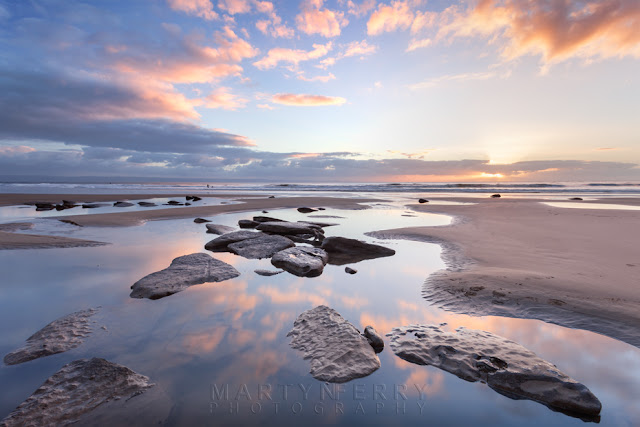 Dunraven Bay sunset with reflected clouds in the foreground by Martyn Ferry Photography