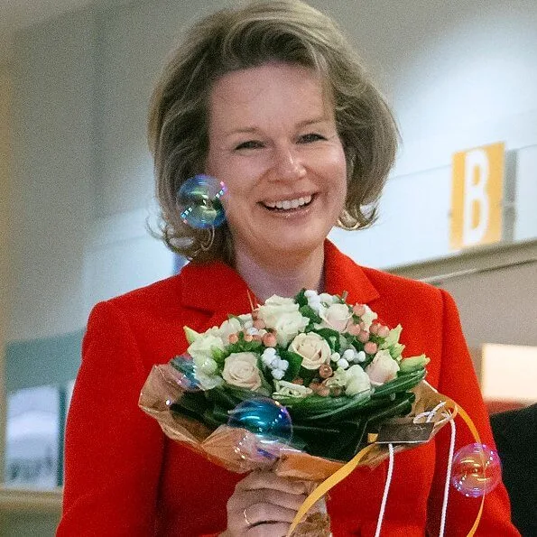 Queen Mathilde visited Queen Fabiola Children's University Hospital. The Queen wore a double breasted orange blazer by Ralph Lauren