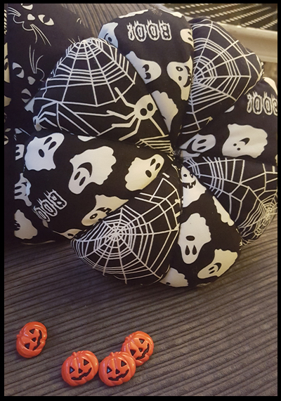 Sew or Glue buttons on cushions for Halloween Decor