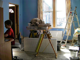 partially painted room with decorators ladder