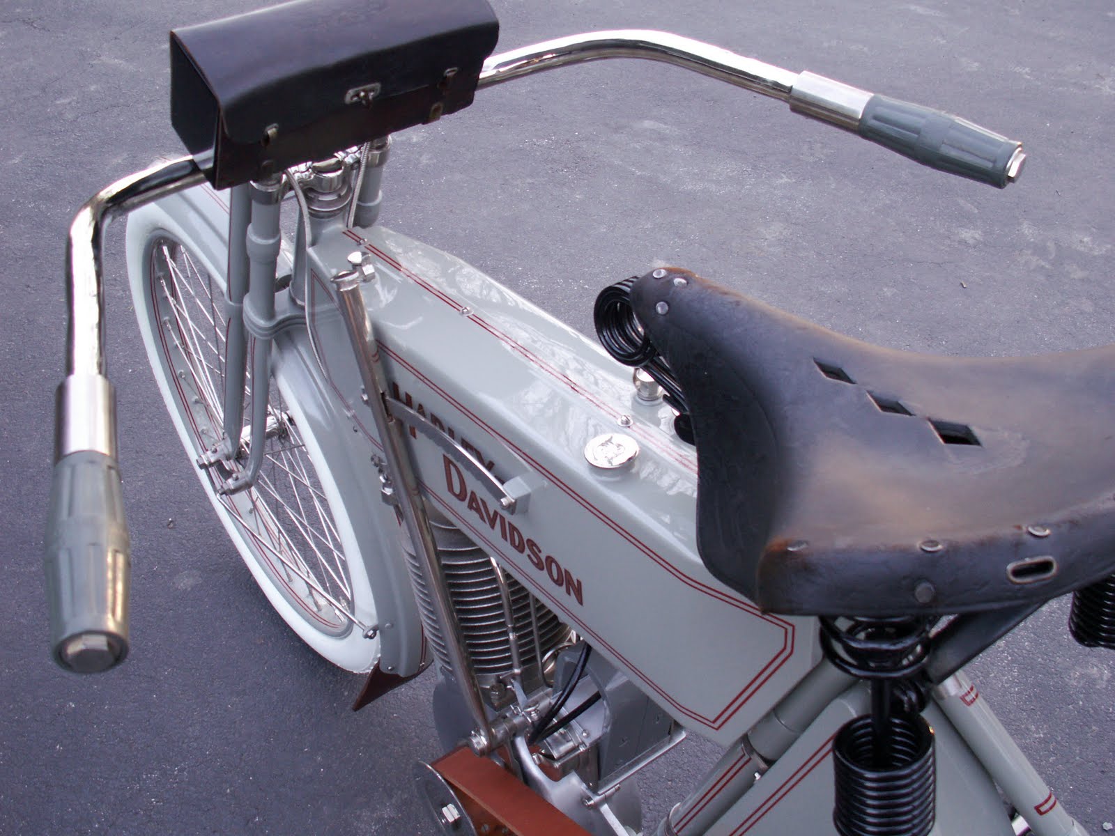 The Harley-Davidson logo circa 1910. Exhaust cut-out offered reduced noise  in town and maximum power and sound when opened.