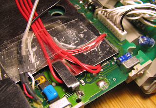[Image: Logic board of the radio with four red botch wires going under an RF shielding plate. The wires are secured using cellotape.]