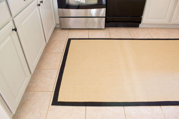 How to diguise ugly flooring. Hide it with a rug! And don't forget the rug pad!