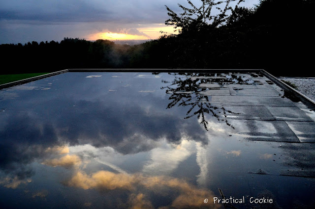 Sunset and reflections in puddles on a roof