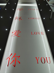 sign on church ceiling with words "Jesus Christ Love You"