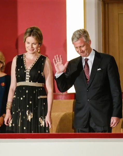 Queen Mathilde at Queen Elisabeth Piano Competition. Queen Mathilde wears Diane Von Furstenberg - DVF Vivanette Embroidered Tulle Goddess Gown. A Bag with a Story Clutch, TIKLI JEWELRY Gold Drop Earrings and Bracelet