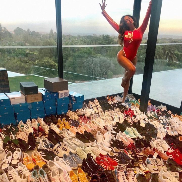 Beyonce poses in a room full of Adidas sneakers