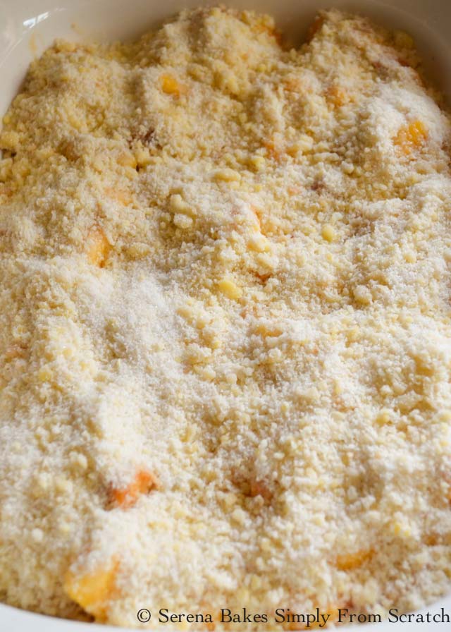 Easy Peach Cobbler Recipe spread topping evenly over top from Serena Bakes Simply From Scratch.