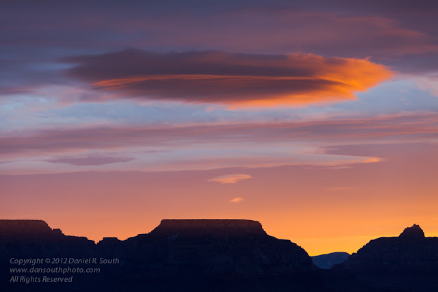 a photography of a lenticular cloud over the grand canyon at sunrise