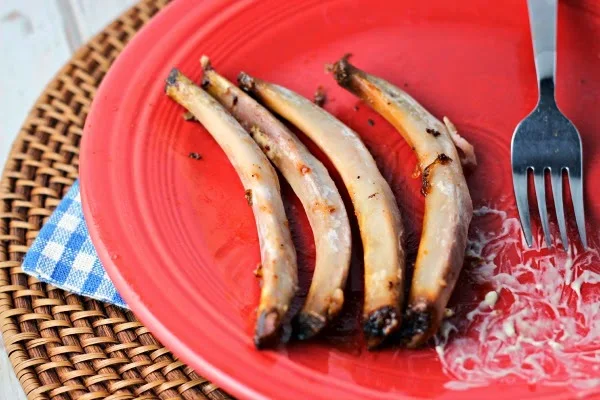 Fall-Off-The-Bone Slow Cooker Ribs  by Renee's Kitchen Adventures bones on a red plate with no meat attached and a fork. 