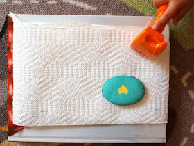 Place paper towel on top use rock or hammer to pound
