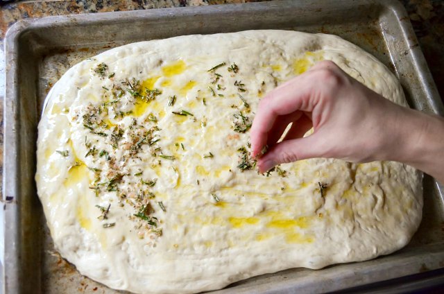 Herbed Focaccia Bread recipe covered with rosemary and parmesan cheese from Serena Bakes Simply From Scratch.